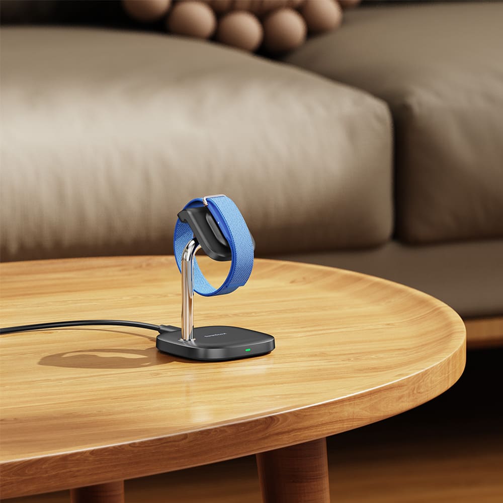 Compact fitbit charger wireless charging station on a living room table with SwanScout S10034FA